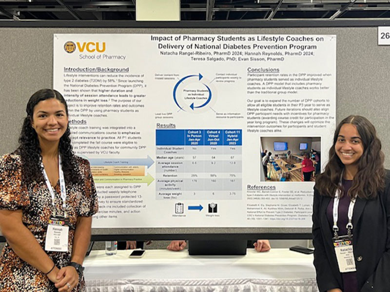 Hannah Reynolds and Natacha Rangel-Rebeiro with poster at ASHP