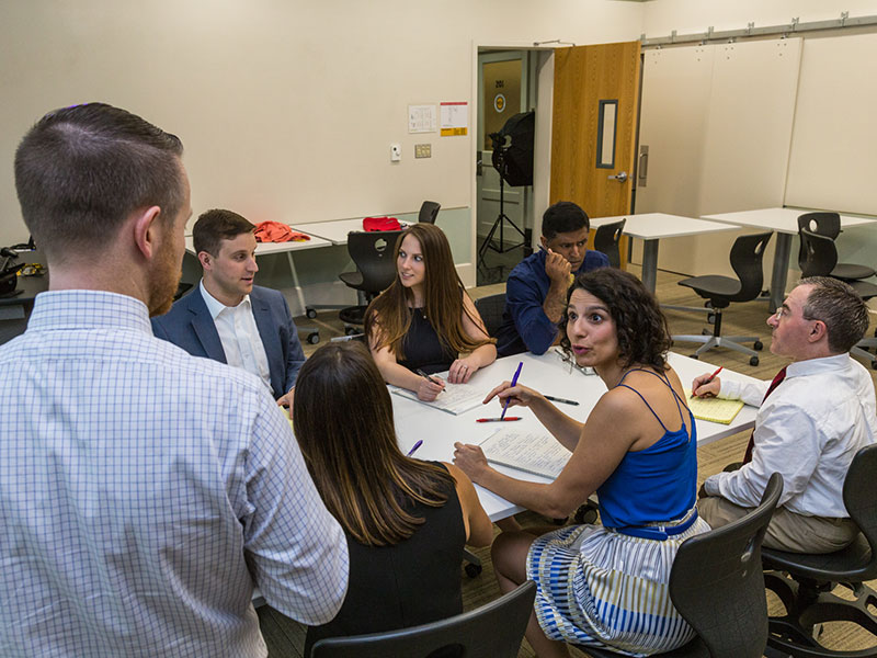 Teresa Salgado bringing up a point during a meeting with other CPPI faculty