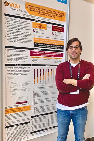 Vasco Pontinha stands in front of poster