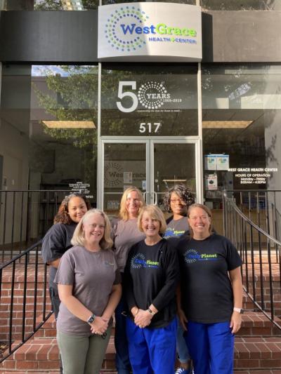 6 pharmacists standing in front of daily planet organization